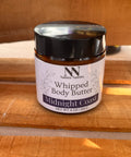 Silky Soft Whipped Body Butter jar in Midnight Coast scent on a wooden surface