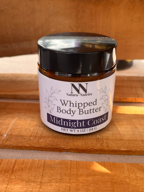 Silky Soft Whipped Body Butter jar in Midnight Coast scent on a wooden surface