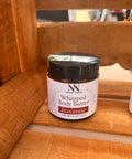 Silky Soft Whipped Body Butter jar in Roxanne scent tucked in a wooden crate corner