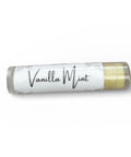Vanilla Mint Olive Oil Lip Balm tube lying on its side on a white background