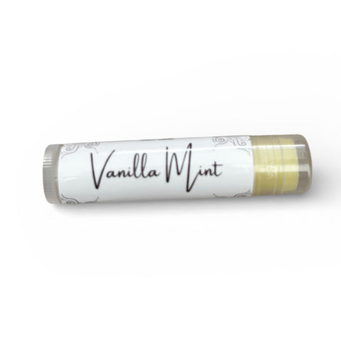 Vanilla Mint Olive Oil Lip Balm tube lying on its side on a white background