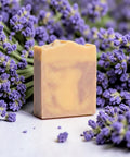 Lavender Dreamin' Handcrafted Soap bar nestled among fresh purple lavender flowers