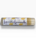 Lavender Lemonade Olive Oil Lip Balm tube lying on its side on a white background