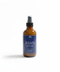 Seraph Room Spray amber glass bottle with blue label on a white background