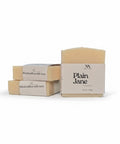 Plain Jane Unscented Handcrafted Soap bars with kraft paper labels, boxed and unboxed, on a white background