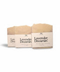 Three Lavender Dreamin' Handcrafted Soap bars wrapped in kraft paper sleeves, side by side on a white background