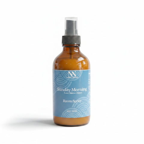 Sunday Morning Room Spray amber glass bottle with blue label on a white background