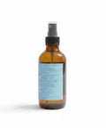 Serenity Essential Oil Room Spray bottle angled view showing the blue label on a white background