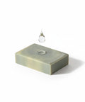 Charcoal & Tea Tree Face Bar Soap single bar with a water droplet falling onto it, on a white background