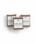 Three bars of Vanilla Sugar Handcrafted Soap with white labels arranged on a white background