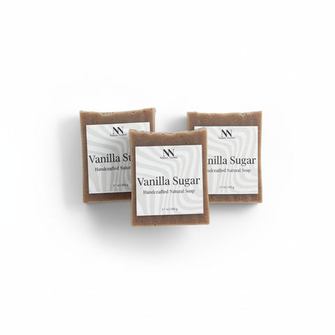 Three bars of Vanilla Sugar Handcrafted Soap with white labels arranged on a white background