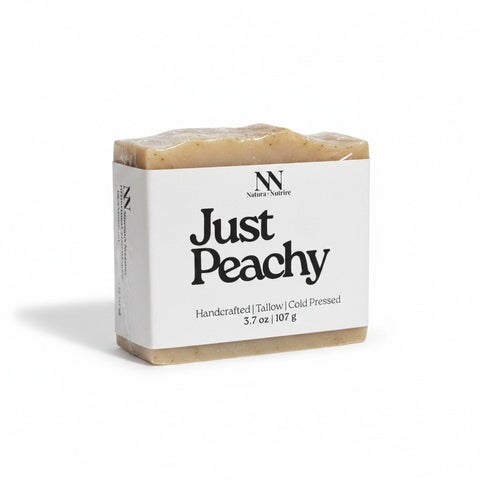 Just Peachy Tallow Soap bar wrapped in kraft paper label on a white background