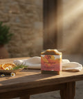 Tuscan Sunset Tallow Soap on a sunlit wooden table with dried orange slices and rosemary