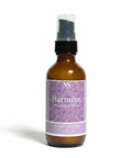 Harmony Magnesium Lotion 2oz spray bottle with purple mandala-patterned label on a white background