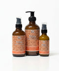 Bliss Magnesium Lotion in three bottle sizes with orange mandala-patterned labels on a white background