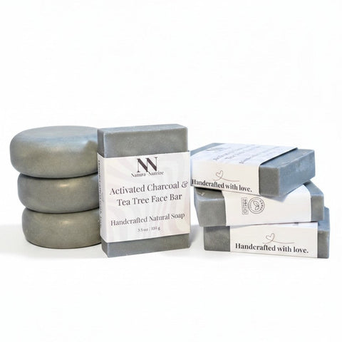 Charcoal & Tea Tree Face Bar Soap round and rectangular bars stacked with their packaging on a white background