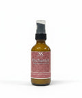 Enchanted Magnesium Lotion 2oz spray bottle with pink mandala-patterned label on a white background