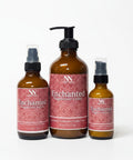 Three Enchanted Magnesium Lotion bottles - 4oz spray, 8oz pump, and 2oz spray - with pink mandala-patterned labels on a white background