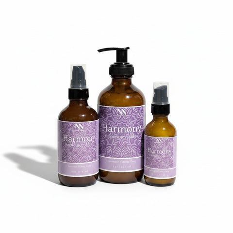 Three Harmony Magnesium Lotion bottles - 4oz spray, 8oz pump, and 2oz spray - with purple mandala-patterned labels on a white background