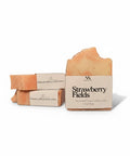 Strawberry Fields Handcrafted Soap bars with kraft paper labels, boxed and unboxed, on a white background