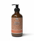 Bliss Magnesium Lotion 8oz pump bottle with orange mandala-patterned label on a white background