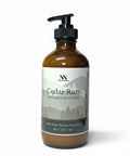 Cedar Rum Magnesium Lotion 8oz pump bottle with green and gray mountain-patterned label on a white background
