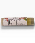 Tropics Pineapple Olive Oil Lip Balm tube with tropical leaf and flower design on a white background
