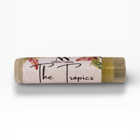 Tropics Pineapple Olive Oil Lip Balm tube with tropical leaf and flower design on a white background