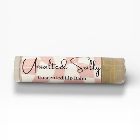 Unsalted Sally Fragrance-Free Olive Oil Lip Balm tube lying on its side on a white background
