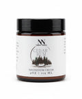 Natura+Nutrire Magnesium Cedar Rum muscle relief cream in a 4oz amber glass jar with a black lid.