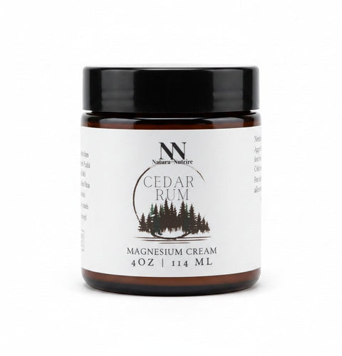 Natura+Nutrire Magnesium Cedar Rum muscle relief cream in a 4oz amber glass jar with a black lid.
