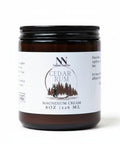 Natura+Nutrire Magnesium Cedar Rum muscle relief cream in an 8oz amber glass jar with a black lid.