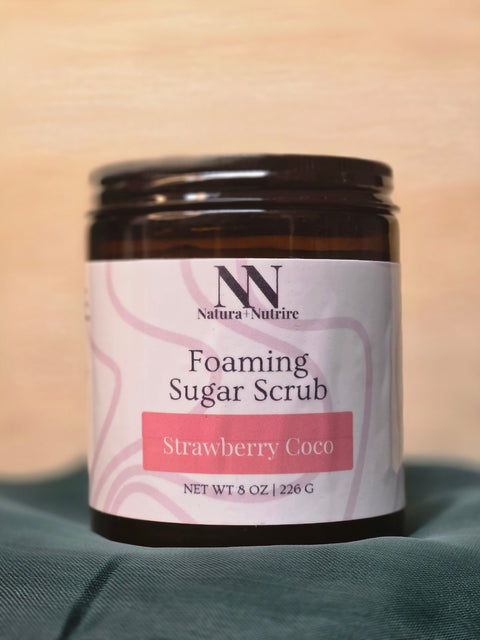 Foaming Sugar Scrub jar in Strawberry Coco scent on a teal fabric background
