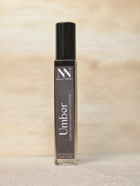 Umber Handcrafted Non-Toxic Fragrance spray bottle standing on a light wood surface