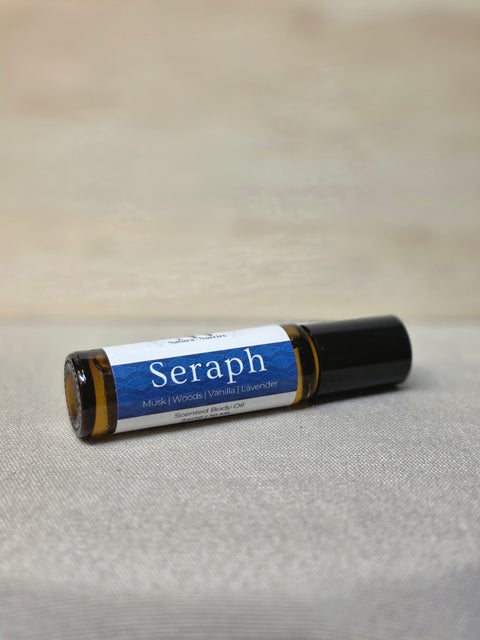 Body Oil Perfume Seraph rollerball bottle lying on its side on a linen surface
