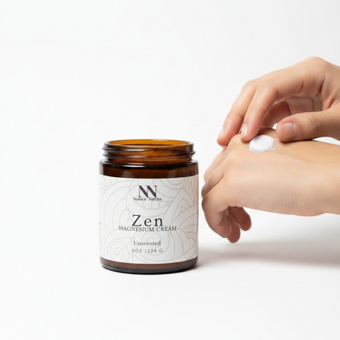 Person applying Zen Magnesium Cream to their hand next to the open jar on a white background