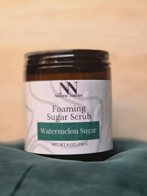 Foaming Sugar Scrub jar in Watermelon Sugar scent on a teal fabric background
