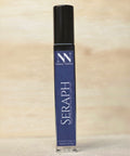 Seraph Handcrafted Non-Toxic Fragrance spray bottle standing on a light wood surface