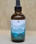 Cedar Rum Magnesium Spray bottle with mountain-themed label on a neutral linen background