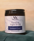 Foaming Sugar Scrub jar in Midnight Coast scent on a teal fabric background