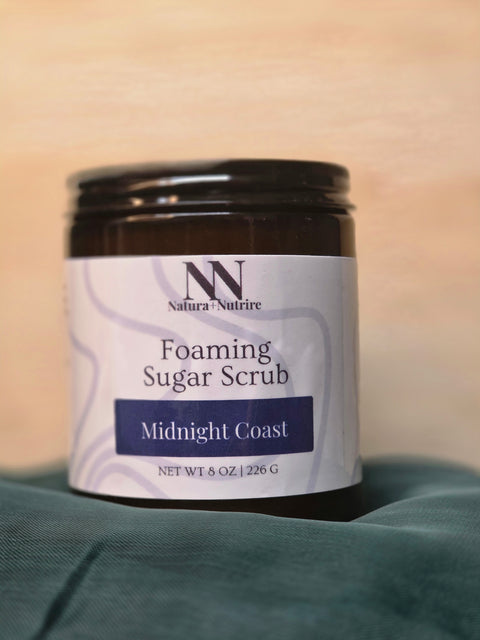 Foaming Sugar Scrub jar in Midnight Coast scent on a teal fabric background