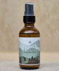 Cedar Rum Magnesium Spray bottle close-up on a neutral tan background