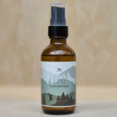 Cedar Rum Magnesium Spray bottle close-up on a neutral tan background