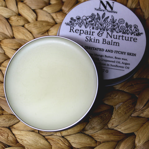 Open Repair & Nurture Skin Balm tin showing creamy balm texture, with the label visible on a woven surface